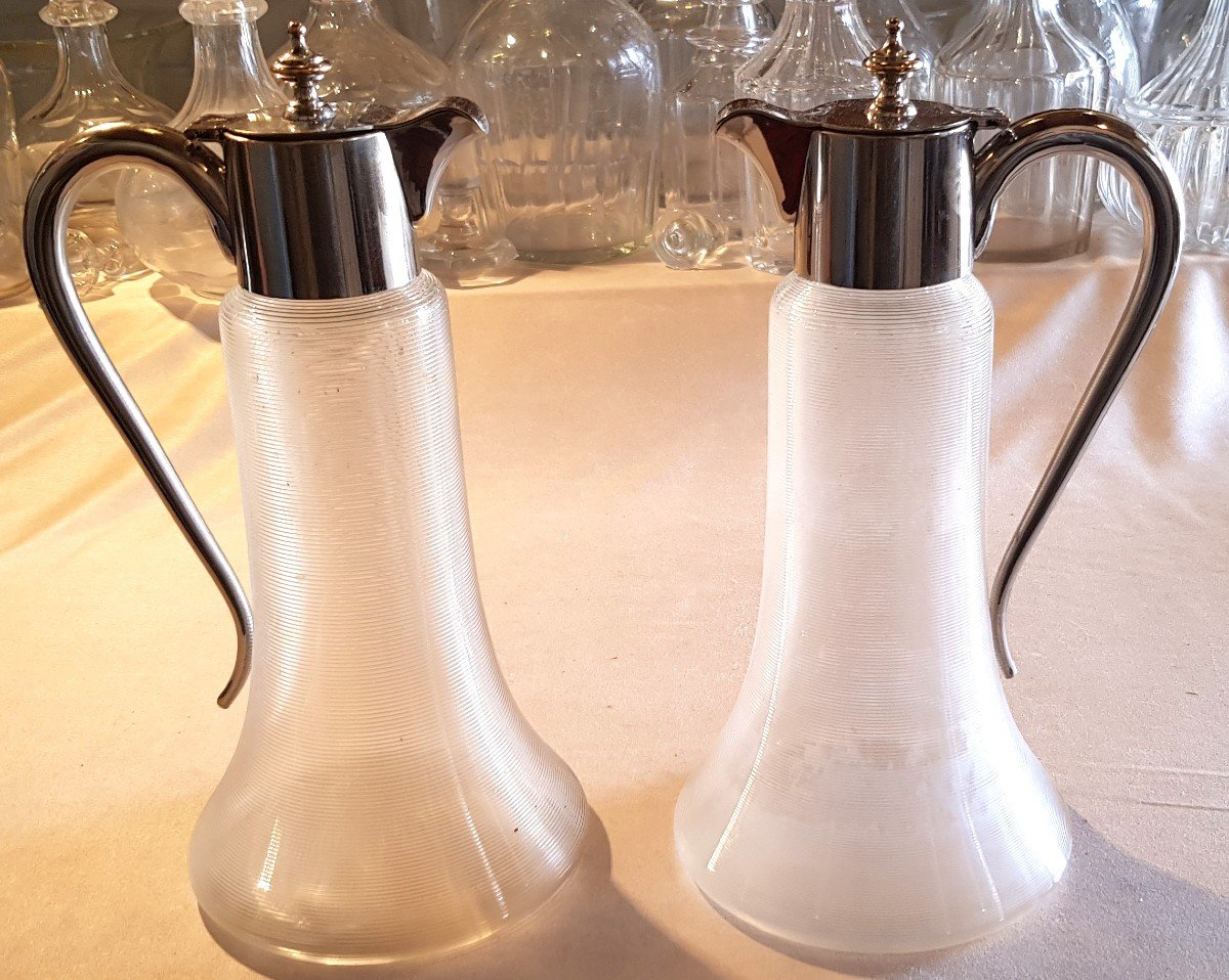 Pair Of Cuspidate Glass Jugs With Metal Handle And Pourer