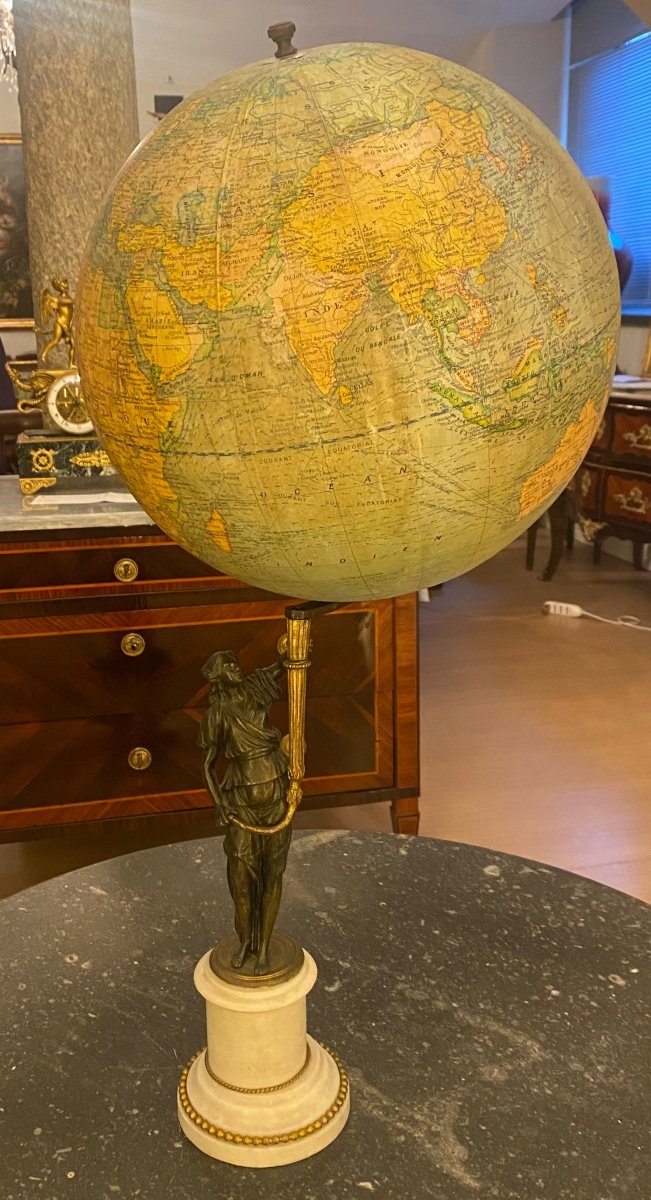 The Globe Is Completely Made Of Cart Paper Supported By A Bronze Figure 