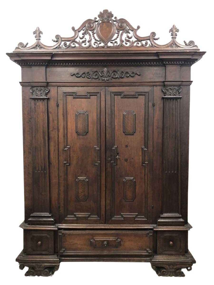 Walnut Wardrobe With Perforated Cymas And Coat Of Arms, With Lily Of The Farnese Family, Parma