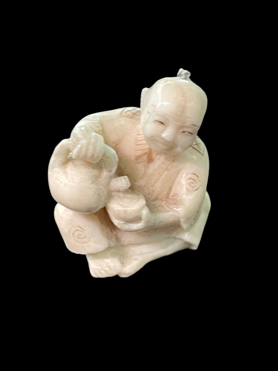 Ivory Netsuke Depicting A Seated Male Figure Pouring Tea. -photo-3