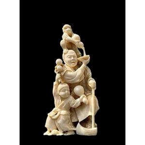 Ivory Okimono Sculpture Depicting A Male Figure With A Child And A Monkey. 