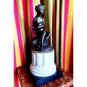 18th Century Patinated Bronze Of A Young Nude Draped Bather, Seated On A Fluted Column Base