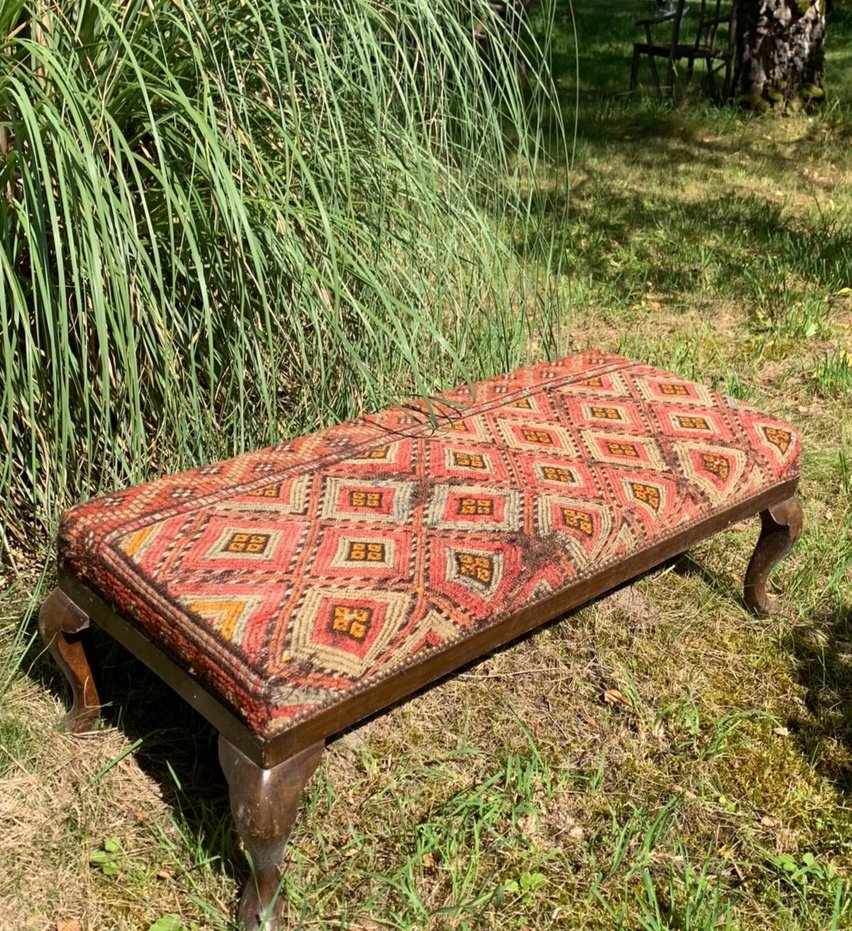 English Bench Covered With An Oriental Rug 