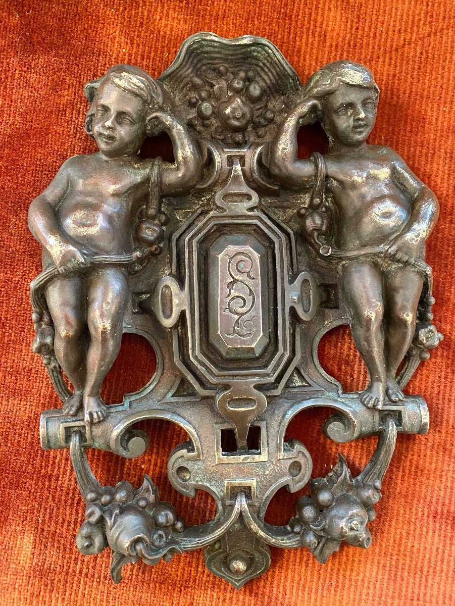 19th Decorative Bronze In The Shape Of A Crest Or Shield. Putti And Flower Garlands.