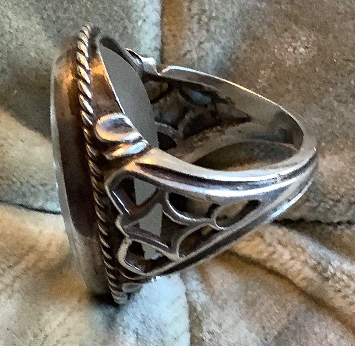 A Silver Ring With Glass Inlay Of A Woman's Profile -photo-1