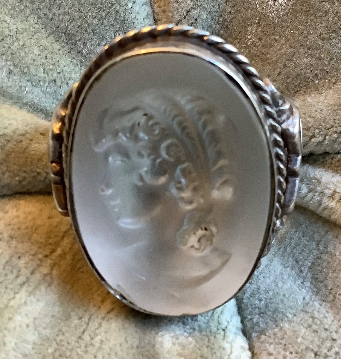 A Silver Ring With Glass Inlay Of A Woman's Profile 