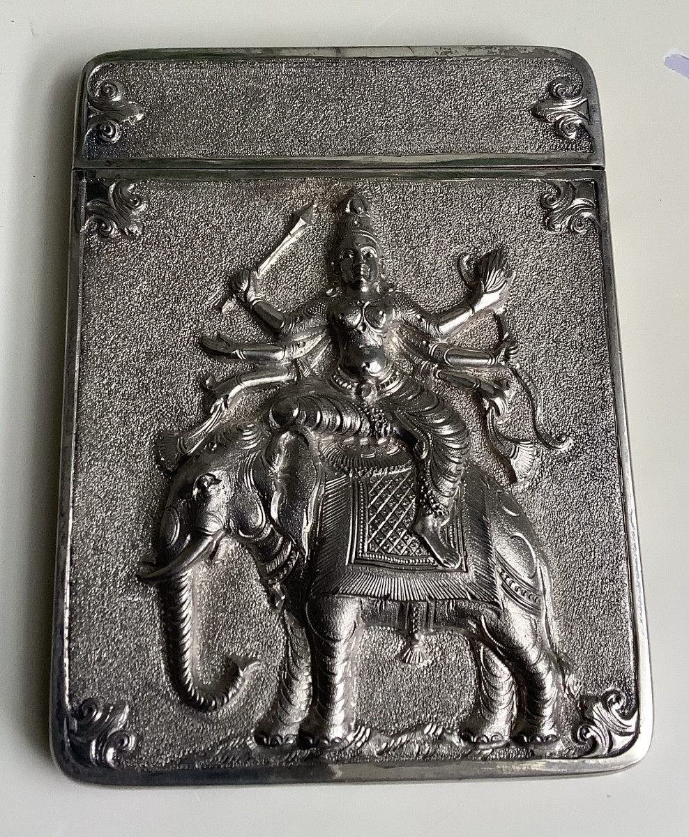 A Silver Business Card Decorated With Shiva On An Elephant 