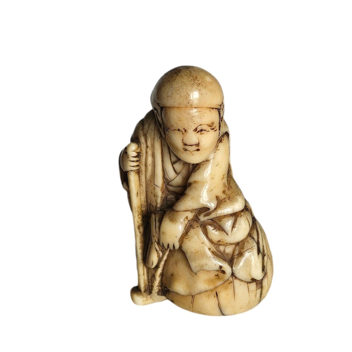 Netsuke Depicting A Traveler Sitting On His Bag