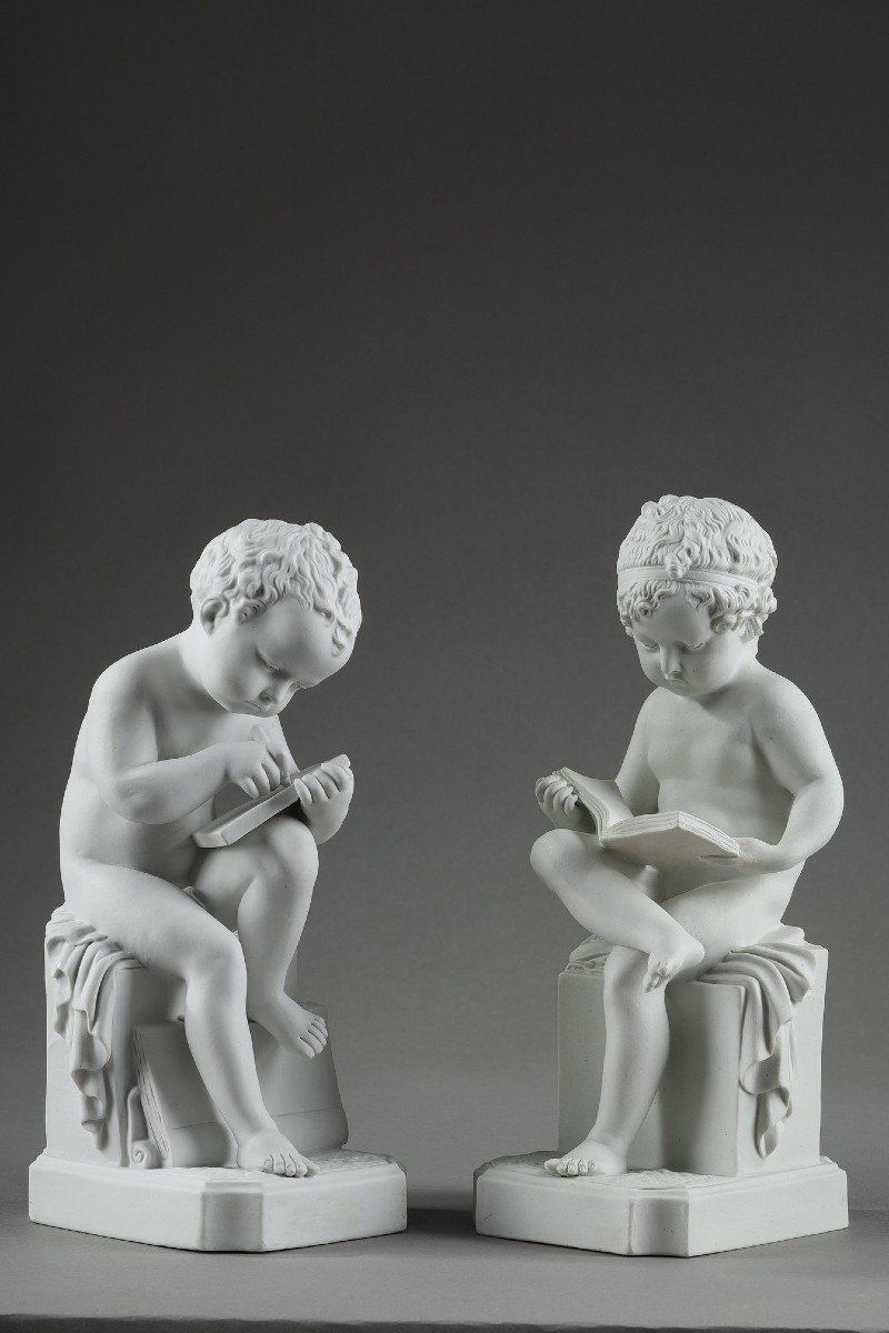 Two Biscuit Subjects Representing A Child Reading And A Child Drawing