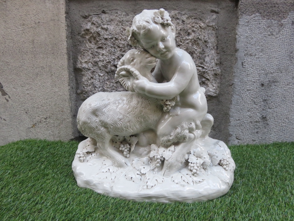 Groupe en porcelaine présentant un petit satyre et un bélier signé Joseph .d' Aste Capodimonte 