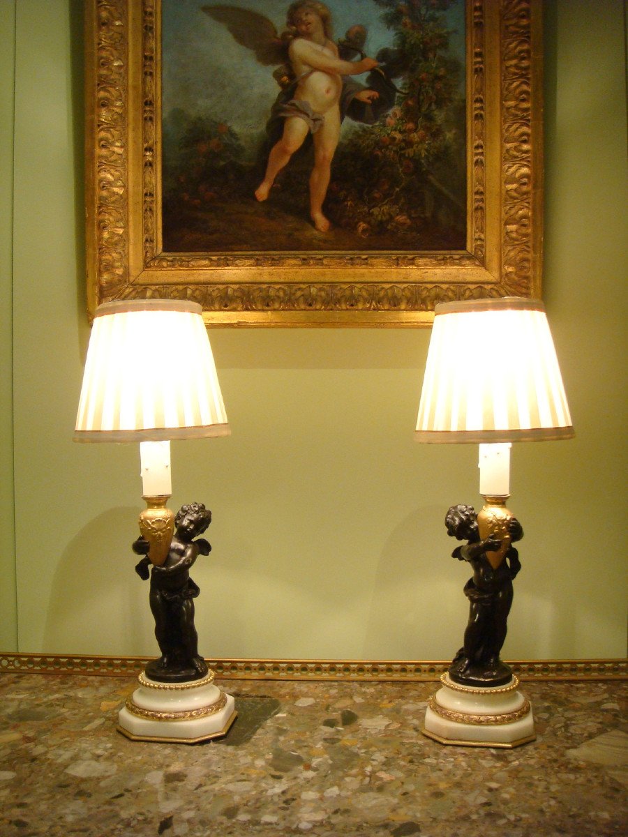 Pair Of Bronze Lamps With Winged Cupids