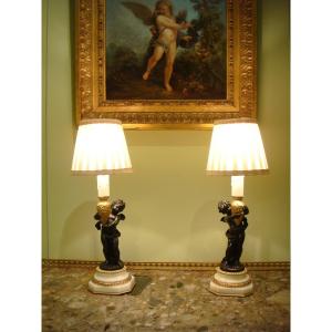 Pair Of Bronze Lamps With Winged Cupids