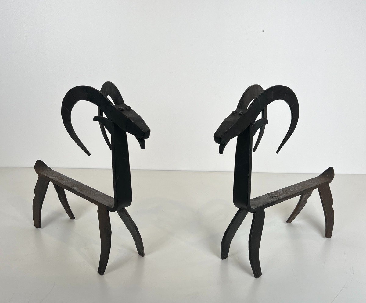 Pair Of Wrought Iron Andirons Representing A Goat. French Work In The Style Of Edouard Schenck.