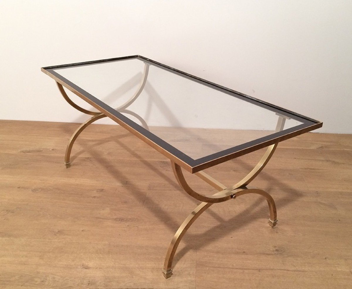 Rectangular Brass Coffee Table With Clear Glass Top Surrounded With Black Lacquered Edges.