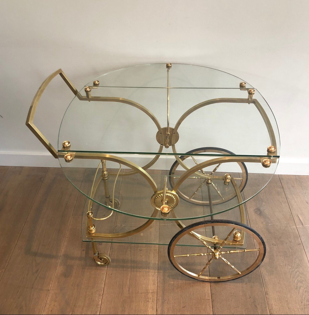 Maison Bagués. Rare Neoclassical Style Brass And Glass Drinks Trolley With Folding Rounded Glass Sides. French. Circa 1940