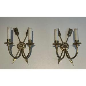 Pair Of Bronze Wall Sconces Presenting Two Crossed Arrows. French Work In The Empire Style. 