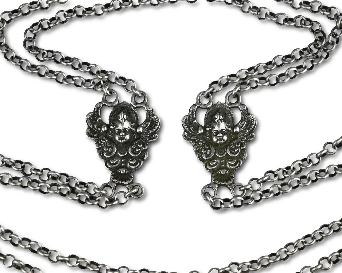 Silver Double Long Chain Set With Putto Heads. Italian, 17th Century.