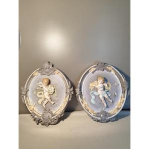 Two Large Biscuit Medallions Decorated With Cherubs. Height 43 Cm