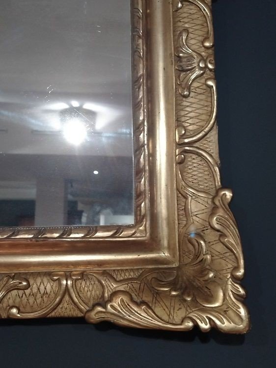 Mirror In Gilded And Carved Wood. Floral Motifs Adorn The Rich Coping-photo-2