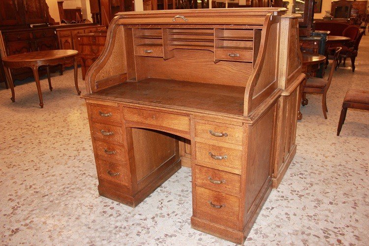 American Roll-top Desk From The Early 1900s, Made Of Oak. It Features A Writing Surface-photo-1