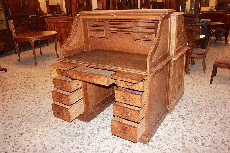 American Roll-top Desk From The Early 1900s, Made Of Oak. It Features A Writing Surface-photo-2