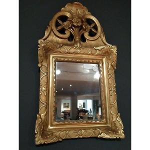 Mirror In Gilded And Carved Wood. Floral Motifs Adorn The Rich Coping