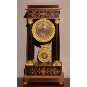 French Clock From The Mid-1800s, Charles X Style, In Boxwood And Ebonized Wood. It Features Ric