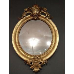 French Oval Mirror In Gilded Wood, With Engraving On The Edges And Carved Molding