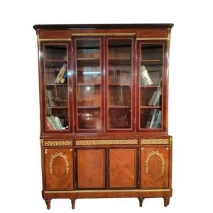 Beautiful And Elegant Bookcase With Four Glass Doors At The Top And Four Closed Doors At The Bo