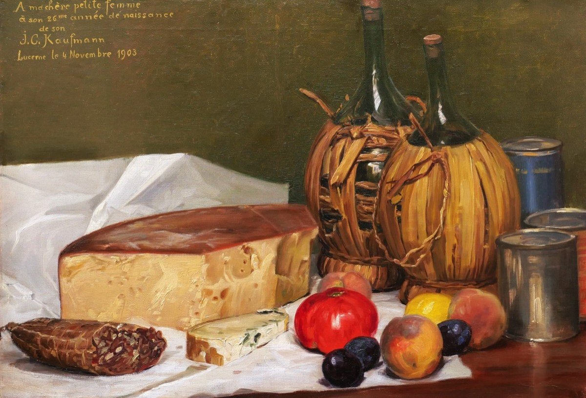 Josef Klemens KAUFMANN, Nature morte aux fruits et légumes, fromage, boîtes, vins et saucisson