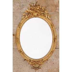 Grand miroir ovale en bois et stuc doré d'époque Napoléon III