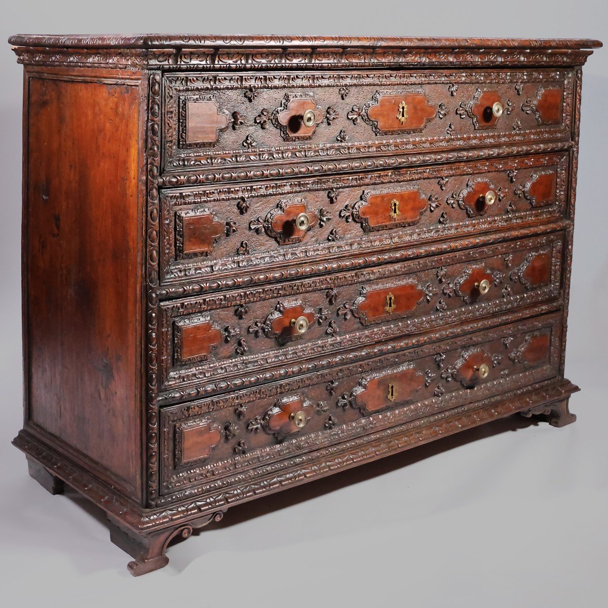 An Italian Carved Walnut Chest Of Drawers, Lombardy, Late 17th Early 18th Century