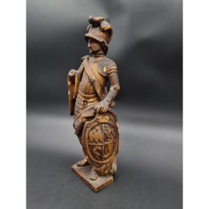 Golden Wood Sculpture Of A Knight In Armor Holding A Shield With Coat Of Arms