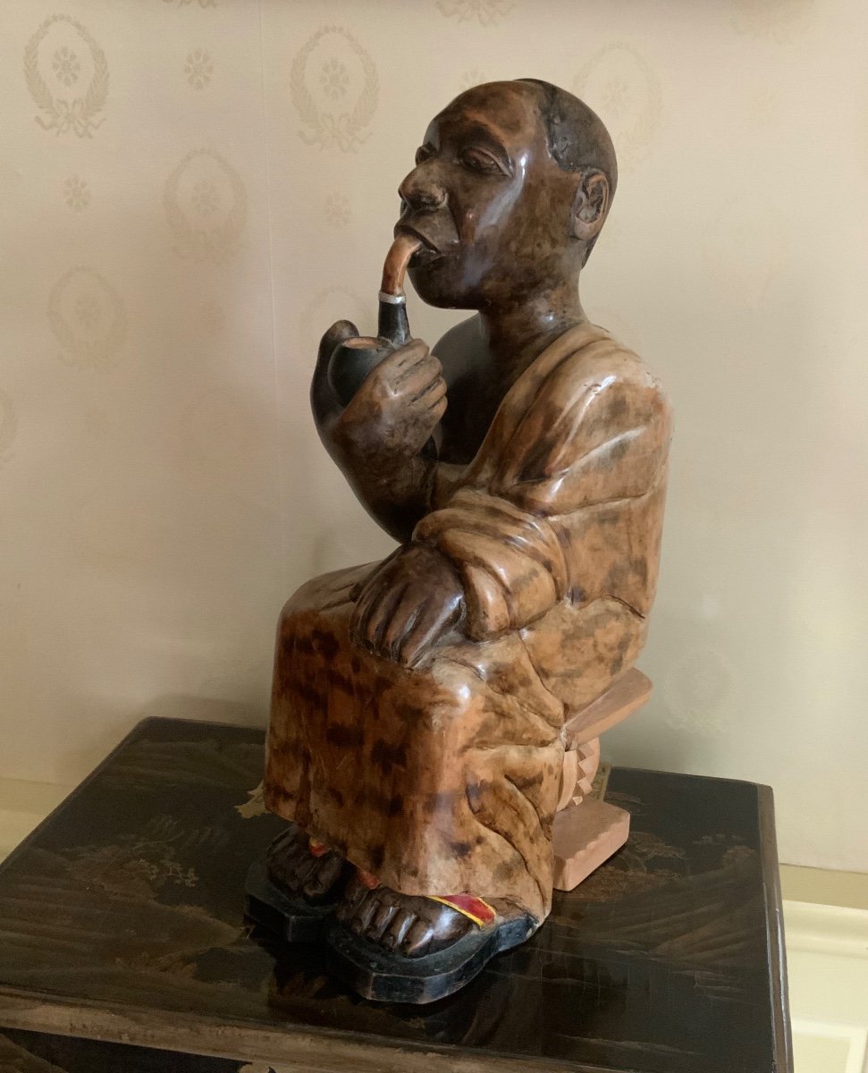 Wooden Statue Of An African Chief Smoking A Pipe