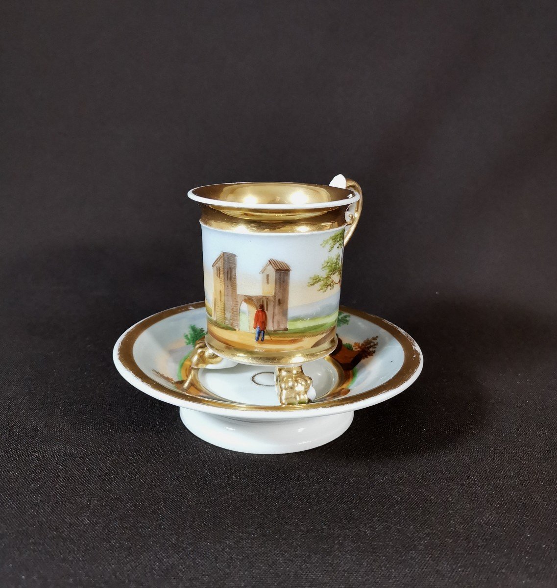 Empire Period, Paris Porcelain Tripod Cup Decorated With A Fantasy Landscape, Rich Gilding And Handle In Motion