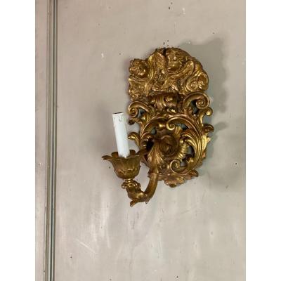 Pair Of Sconces In Carved And Gilded Wood Topped With Two Heads Of Cherubs, Italy