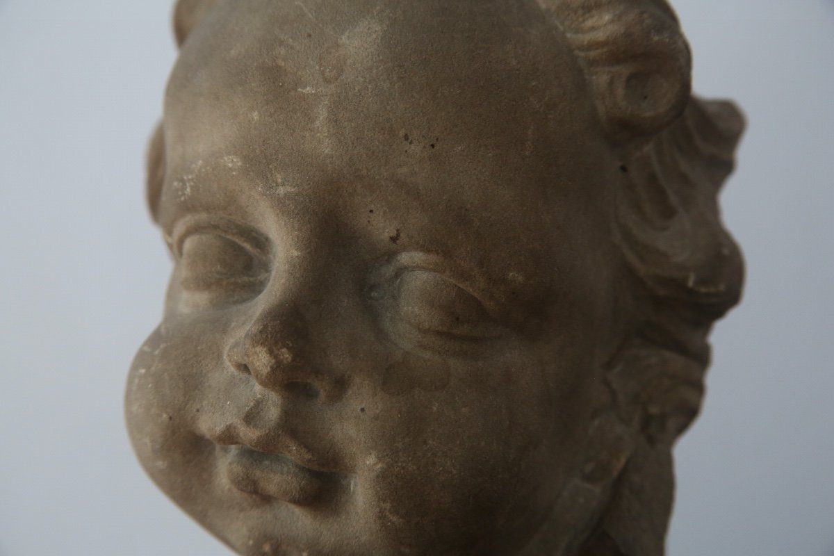 Sculpture In Gray Sandstone Representing The Face Of A Child, Netherlands, Early 18th Century.-photo-1