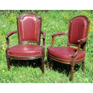 False Pair Of Louis XVI Period Armchairs, Upholstered In Carmine Leather.