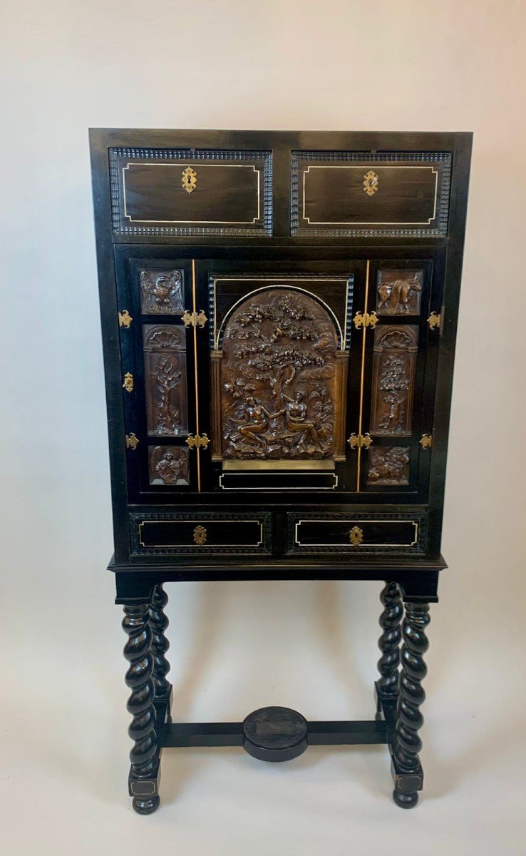 Blackened Wood Cabinet Carved With A Scene Depicting Adam And Eve In The Garden Of Eden 