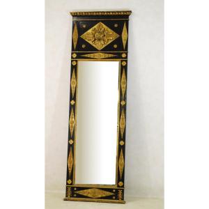 A South German Black-painted, Parcel-gilt And Composition Pier Mirror 