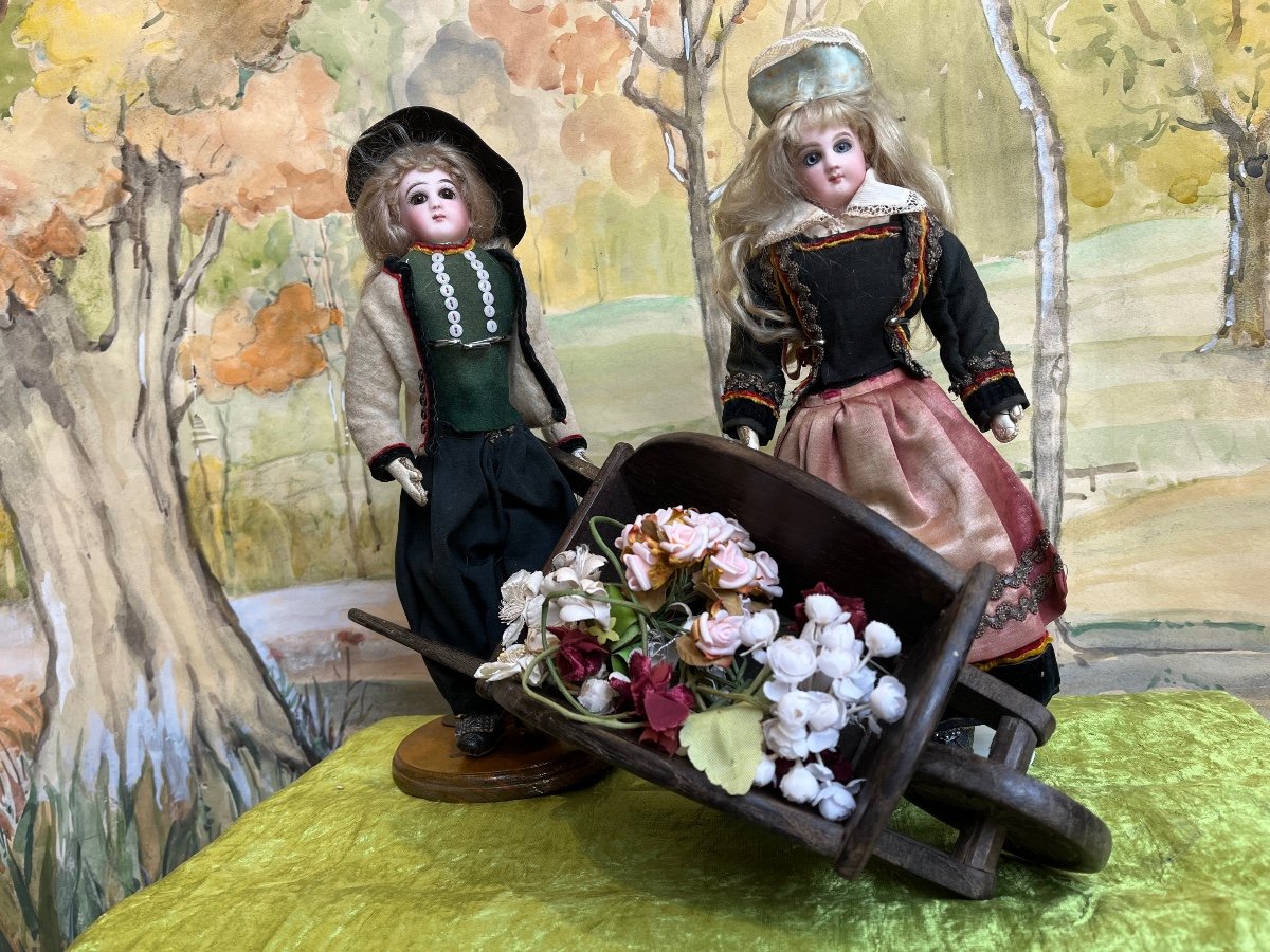 All Original Pair Of French Jumeau Fashion Dolls And Wheelbarrow