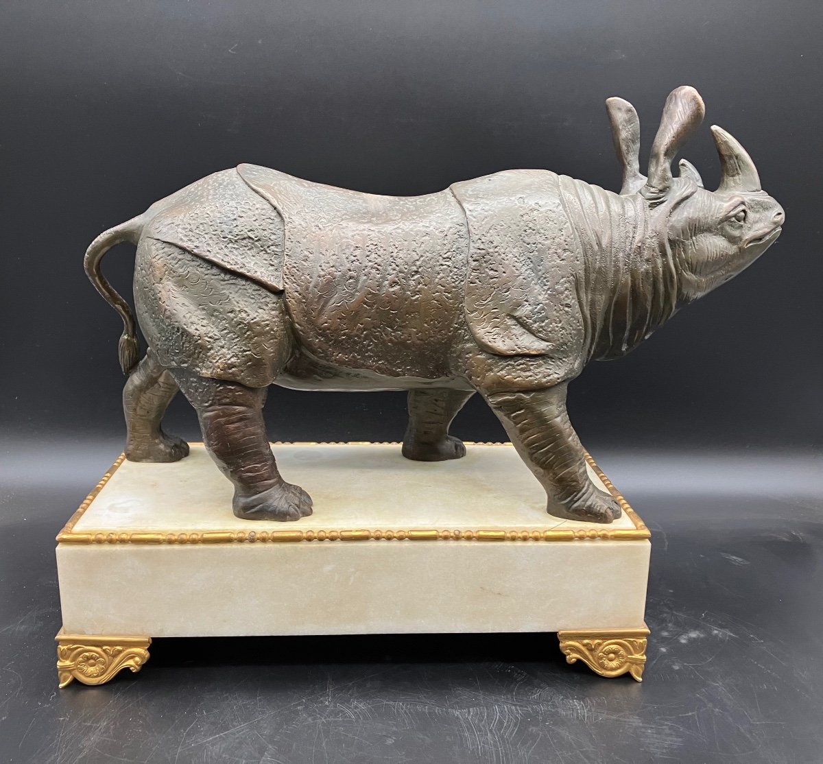 Bronze Rhinoceros On White Marble Base -photo-1