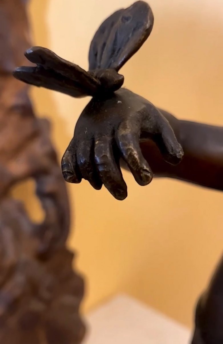 Pair Of Bronze Sculptures With A Burnished  Patina. Two Cherubs Lying On A Richly Decorate Bla -photo-1