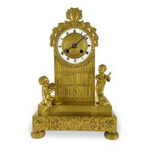 Early 19th Century French Empire Gilt Bronze Mantel Clock With Putti And Library