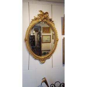 Miroir ovale en  bois et stuc doré fin XIXème 