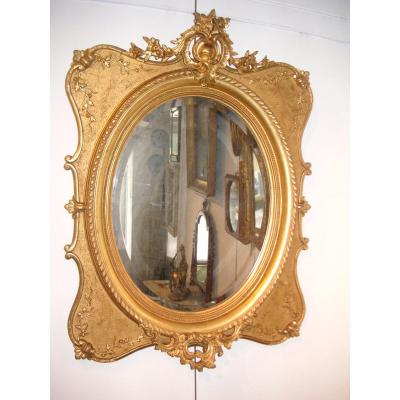 Miroir doré feuille d'or 19ème / glace ovale biseautée