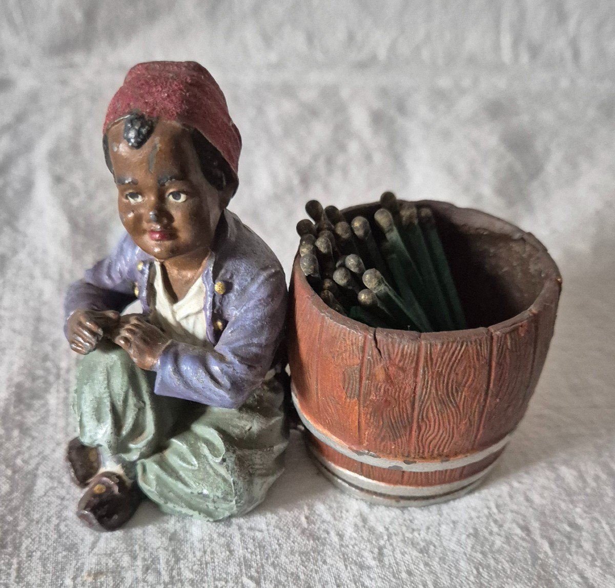 Orientalist Subject Boy Seated Beside A Barrel Forming A Pyrogenic Match Holder 