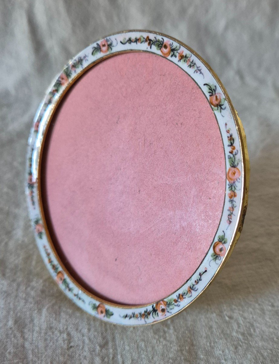 Round Bronze Photo Frame With Roses On White Enamel Background 