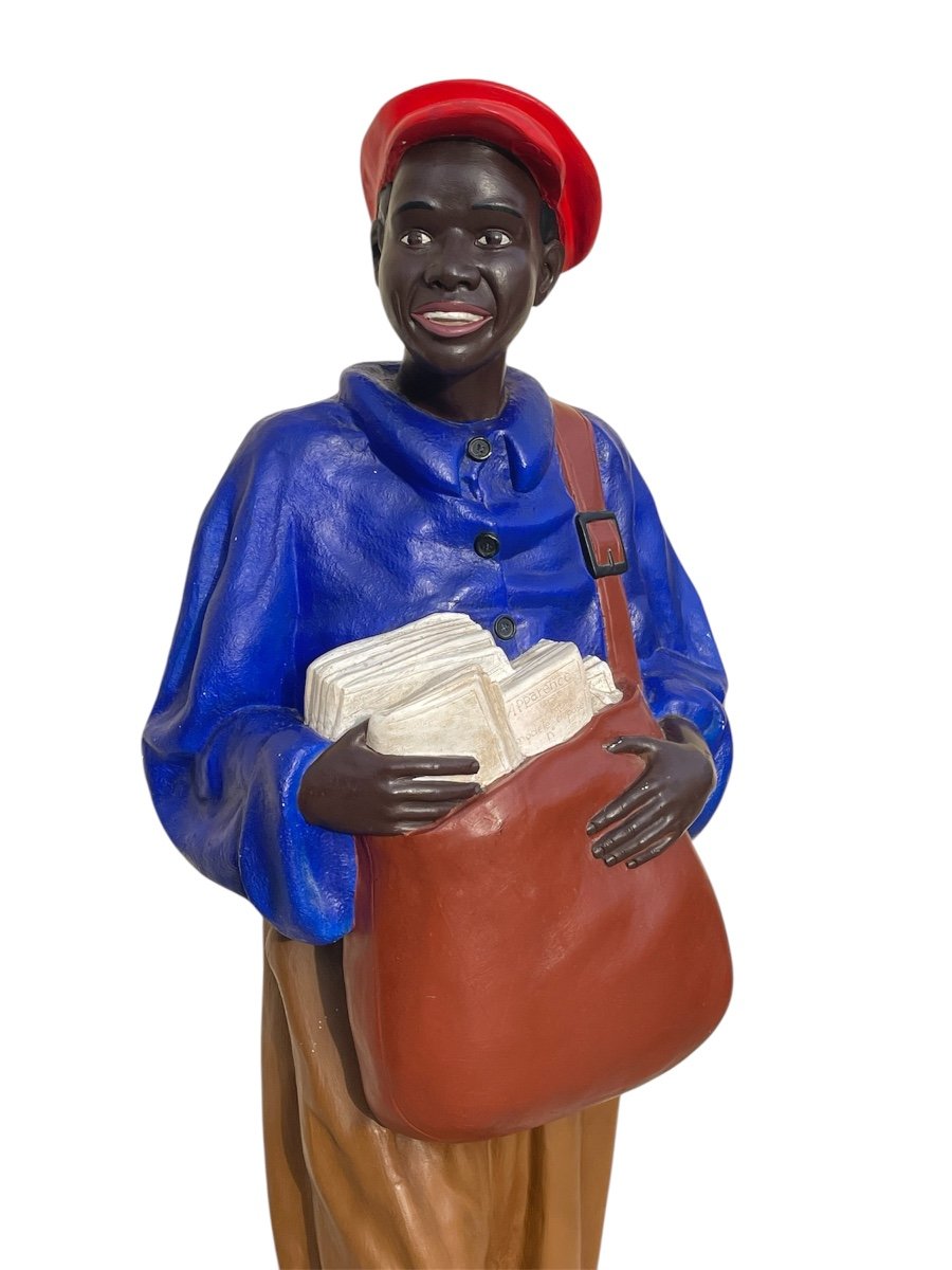 Statue Of A Young African Man Delivering Newspapers-photo-2