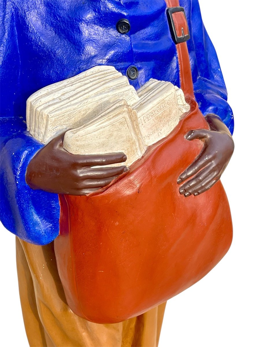 Statue Of A Young African Man Delivering Newspapers-photo-1